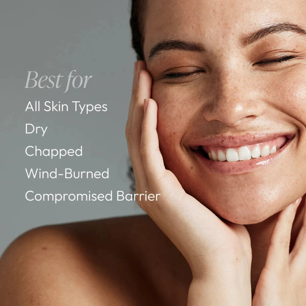 Woman with a happy expression holding her face, with text about skin types on a gray background