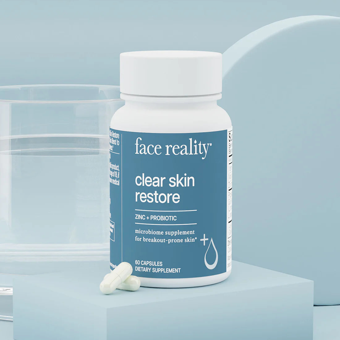 Supplement bottle labeled 'face reality clear skin restore' on a light blue background