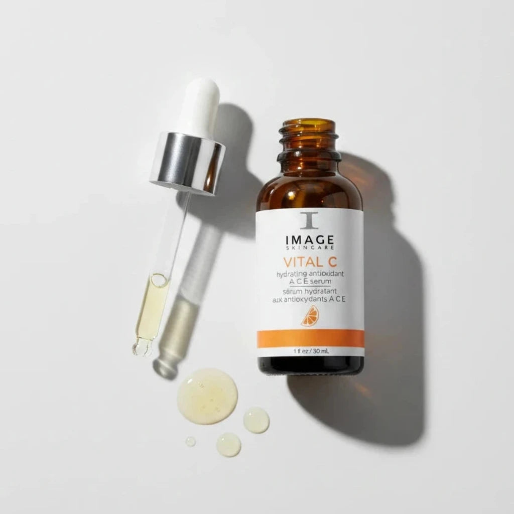 Skincare serum bottle with dropper labeled 'IMAGE Skincare Vital C' on a white background