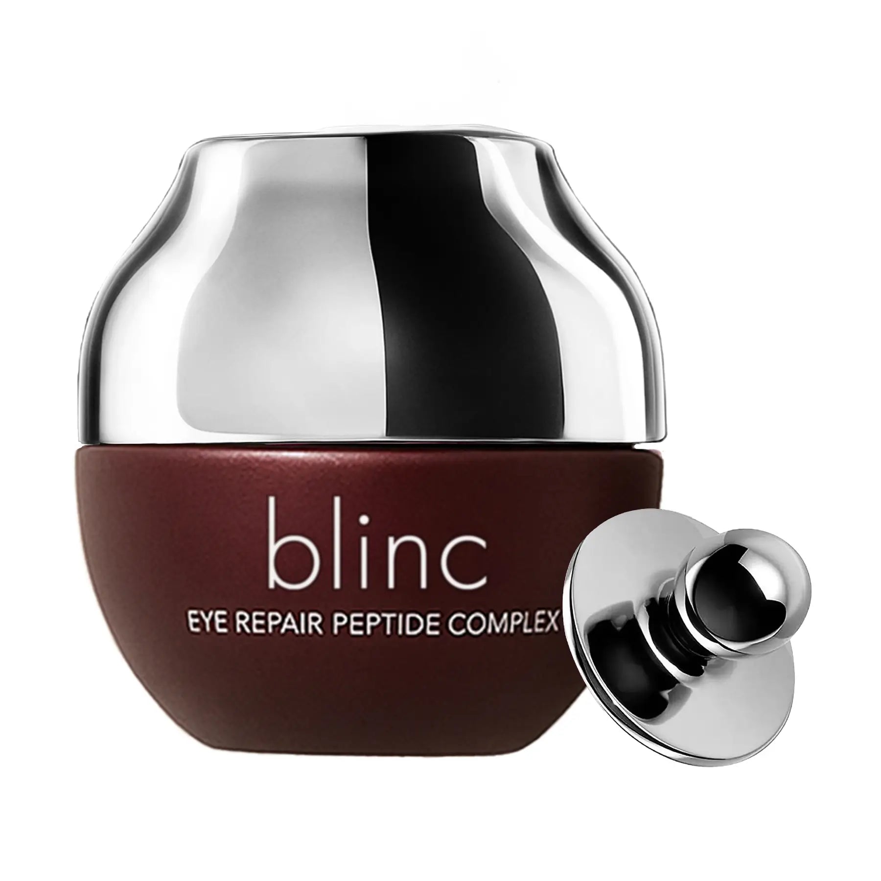 A jar of blinc Eye Repair Peptide Complex with a metallic silver cap and a deep reddish-brown base, shown with its detached silver cap on a white background.