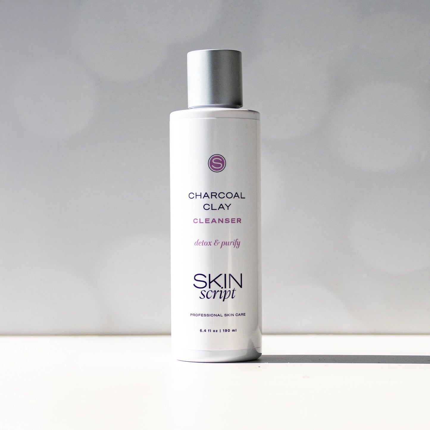 Skincare bottle labeled 'Charcoal Clay Cleanser' by 'Skin Script' on a white background