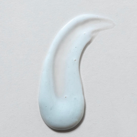 White ceramic teardrop-shaped object on a light gray background