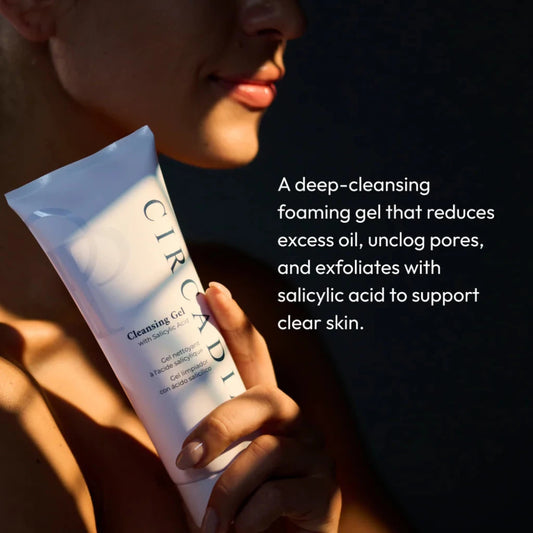 Person holding a Curology cleansing gel tube with product description text.