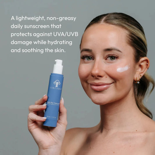 Woman holding a Circadia SPF 37 sunscreen bottle with text about its benefits on a gray background