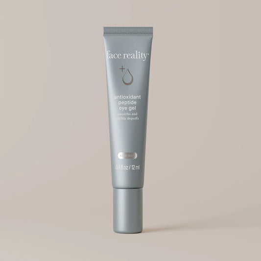 Tube of 'face reality' antioxidant peptide eye gel on a beige background