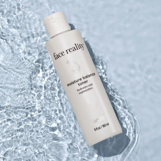 Bottle of 'face reality' moisture balance toner on a water background