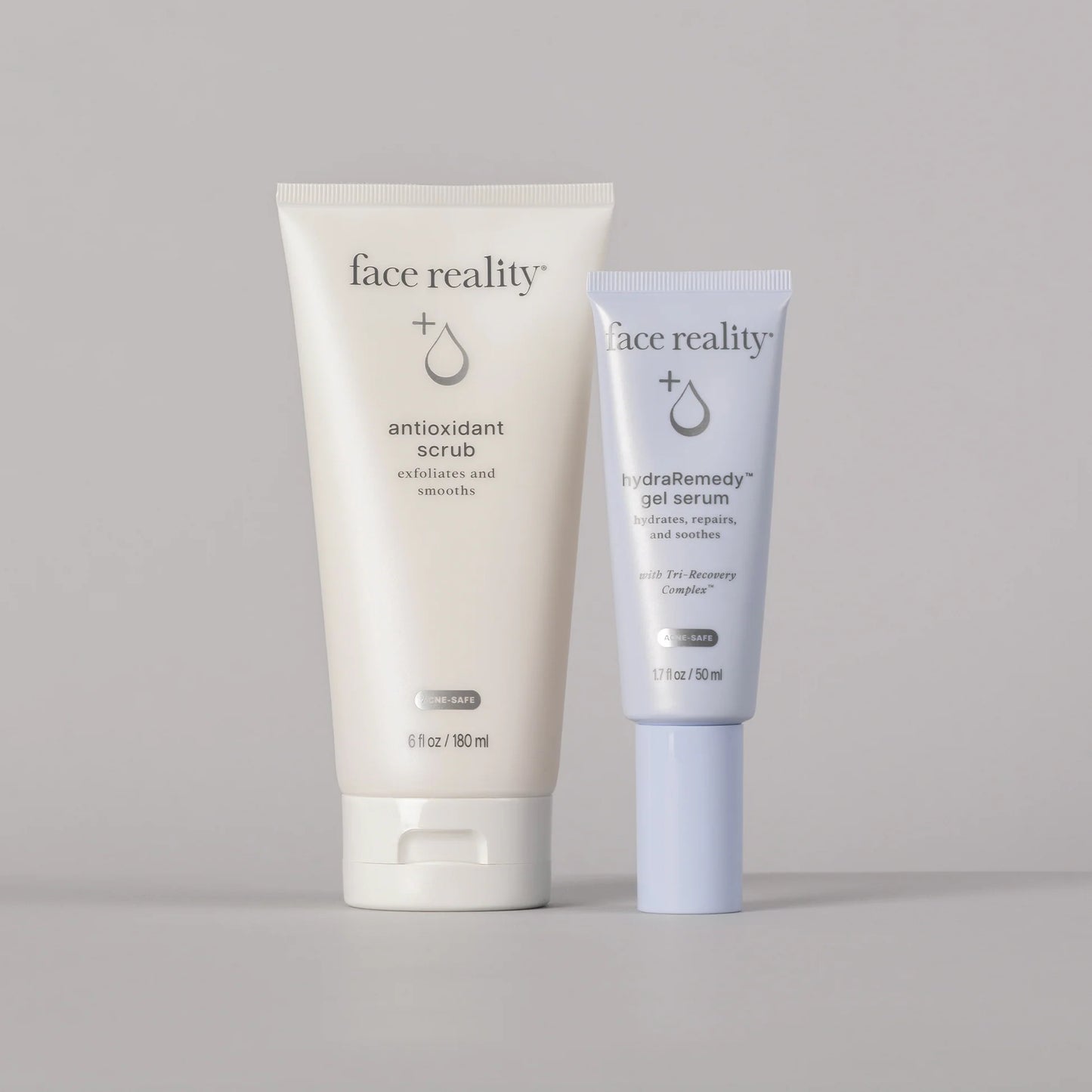 Two skincare products from 'face reality' on a gray background