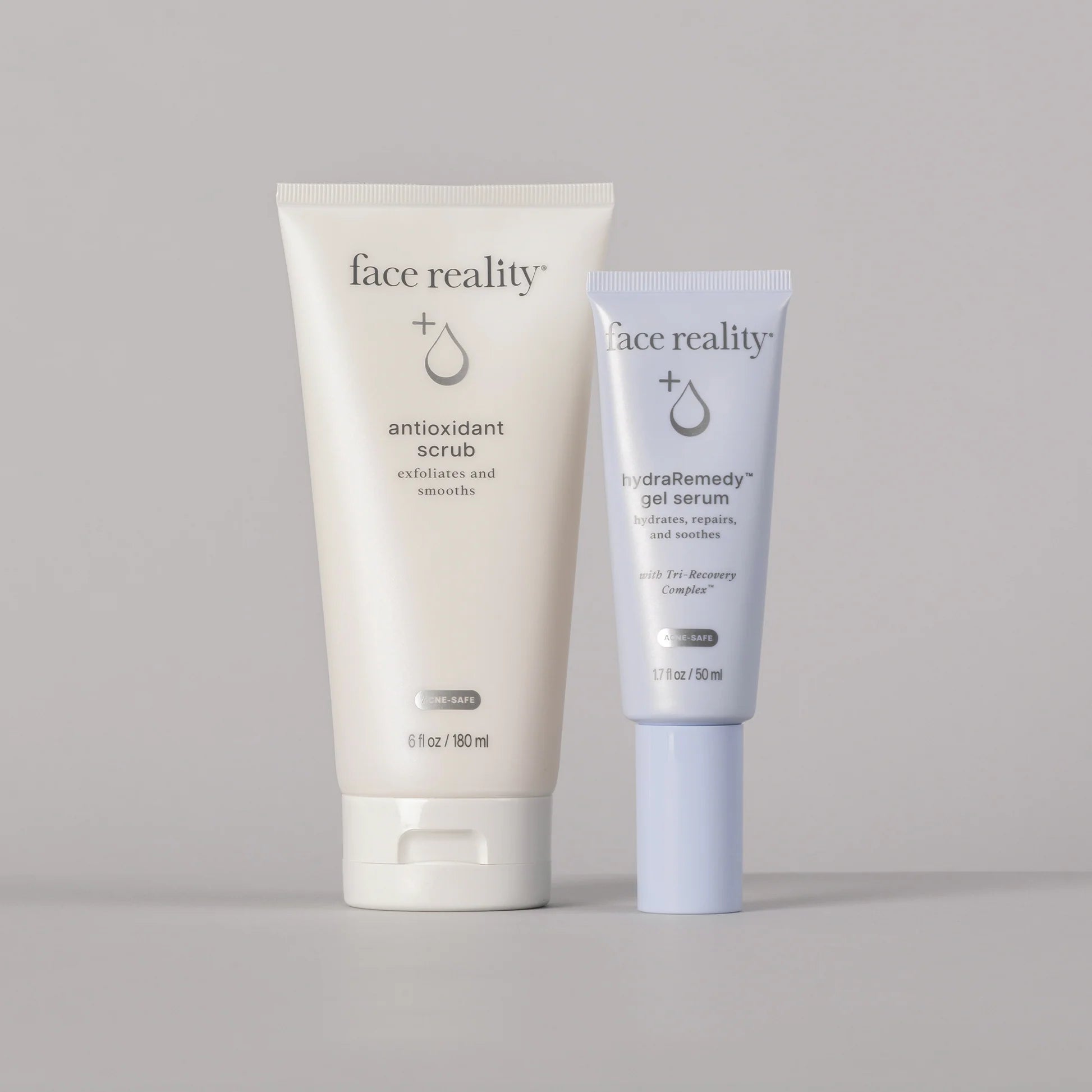 Two skincare products from 'face reality' on a gray background