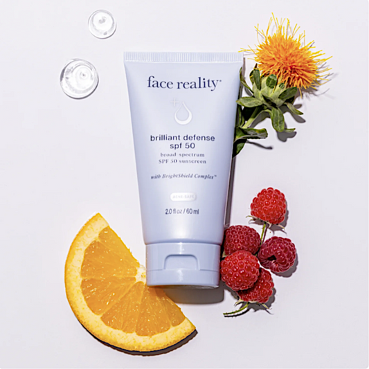Tube of 'face reality' sunscreen with natural elements on a light background