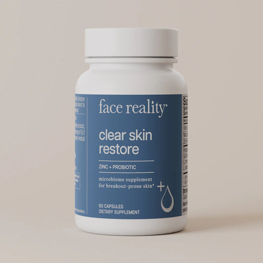 Supplement bottle labeled 'face reality clear skin restore' on a beige background