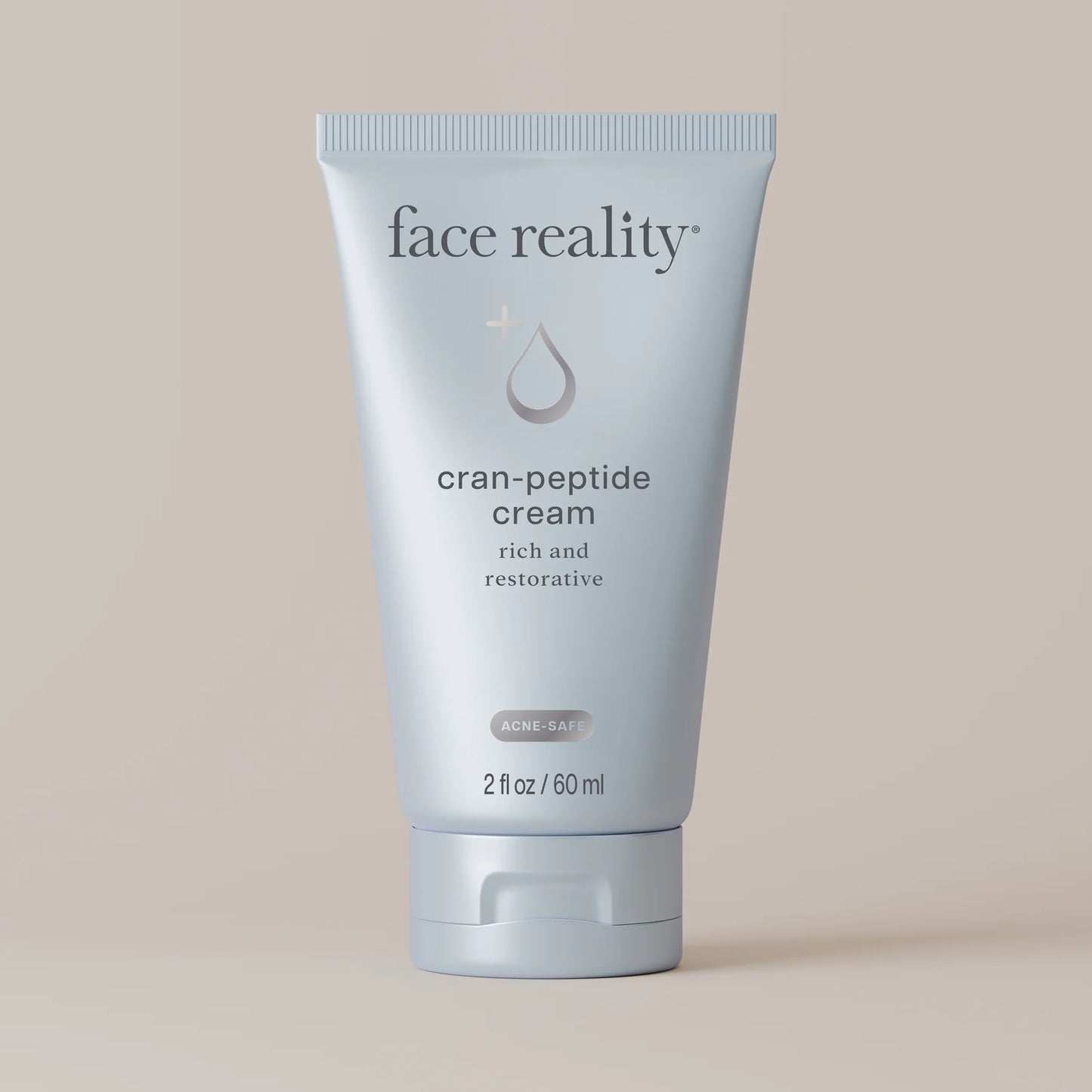 Tube of face reality cran-peptide cream on a beige background