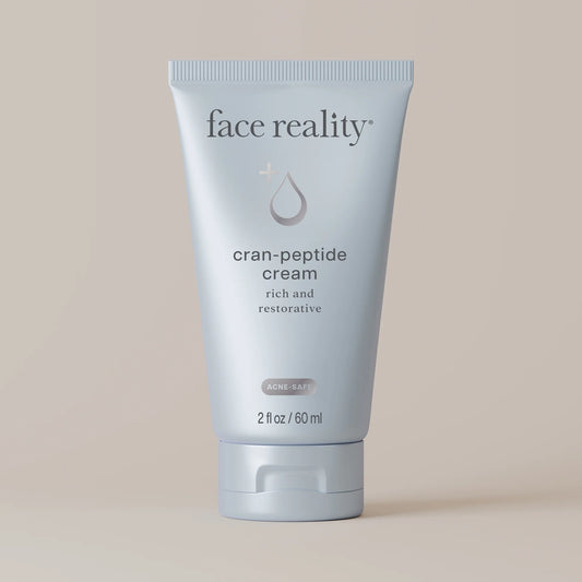 Tube of face reality cran-peptide cream on a beige background