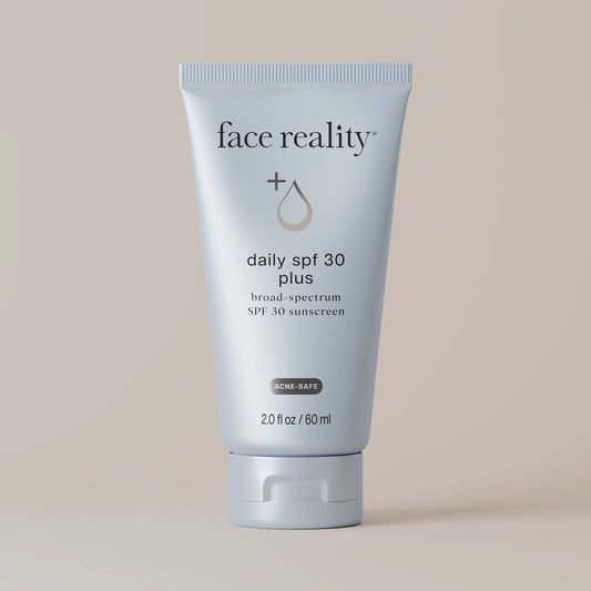 Tube of 'face reality' daily SPF 30 plus sunscreen on a beige background
