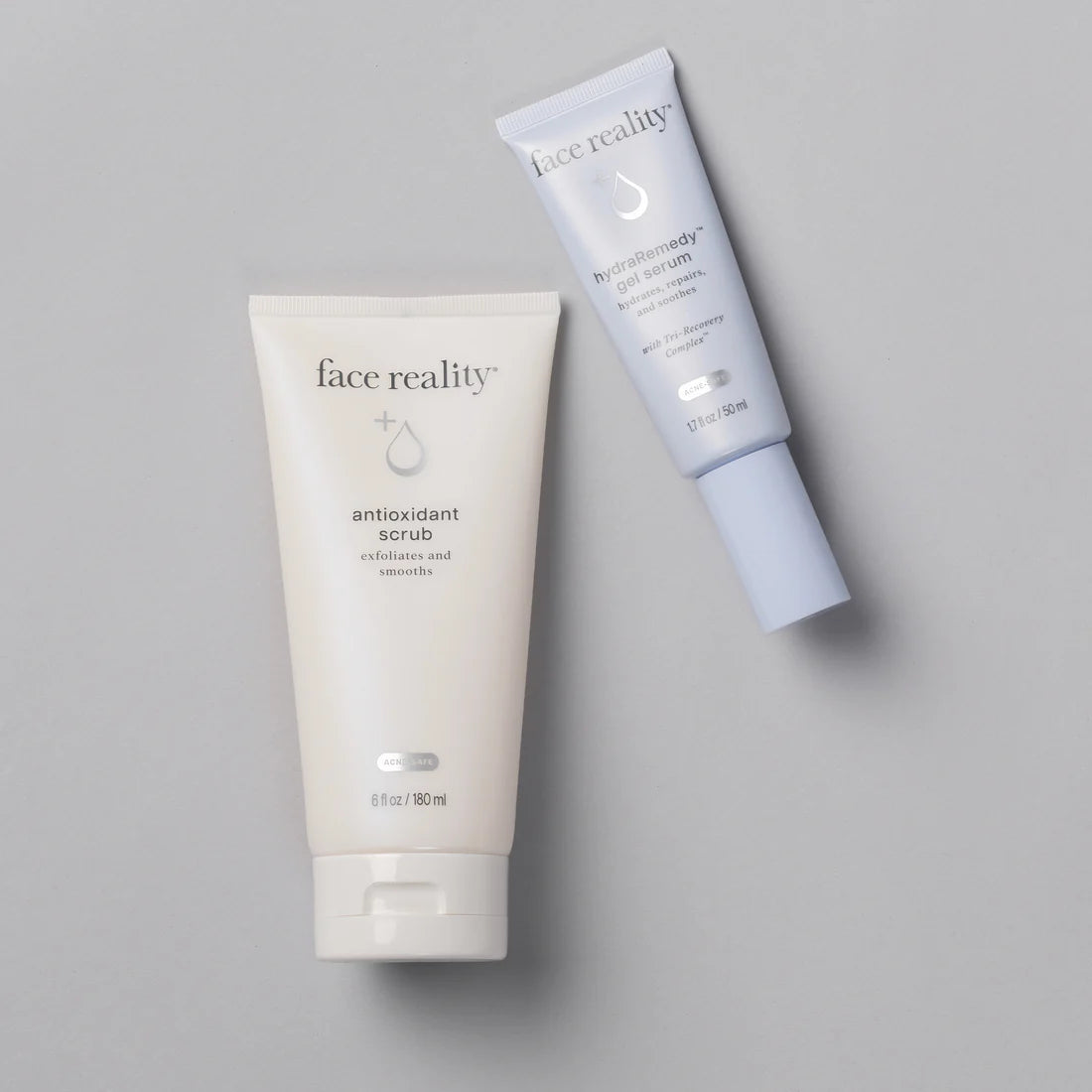 Two skincare products from 'face reality' on a gray background