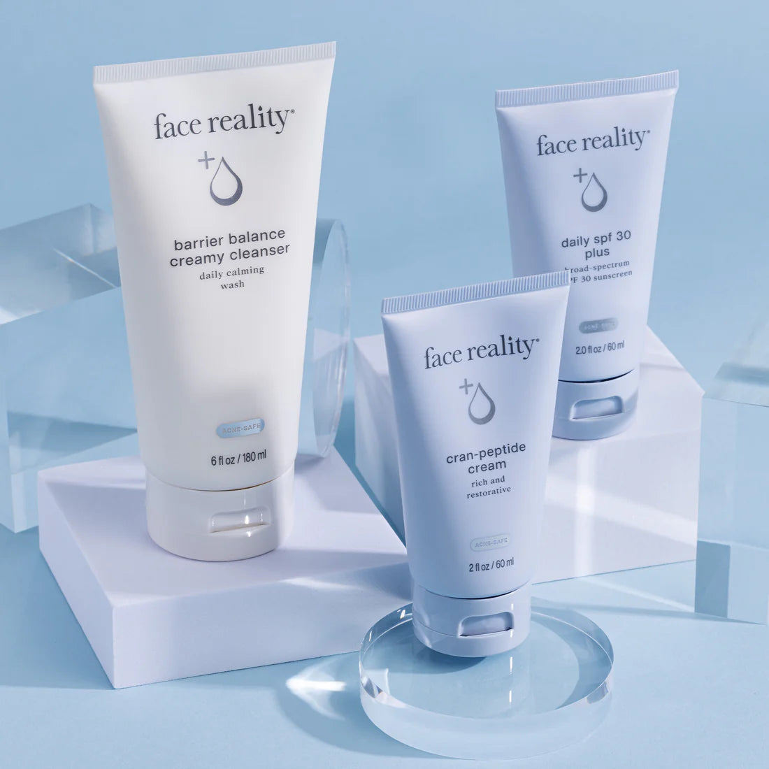 Three 'face reality' skincare products on a light blue background