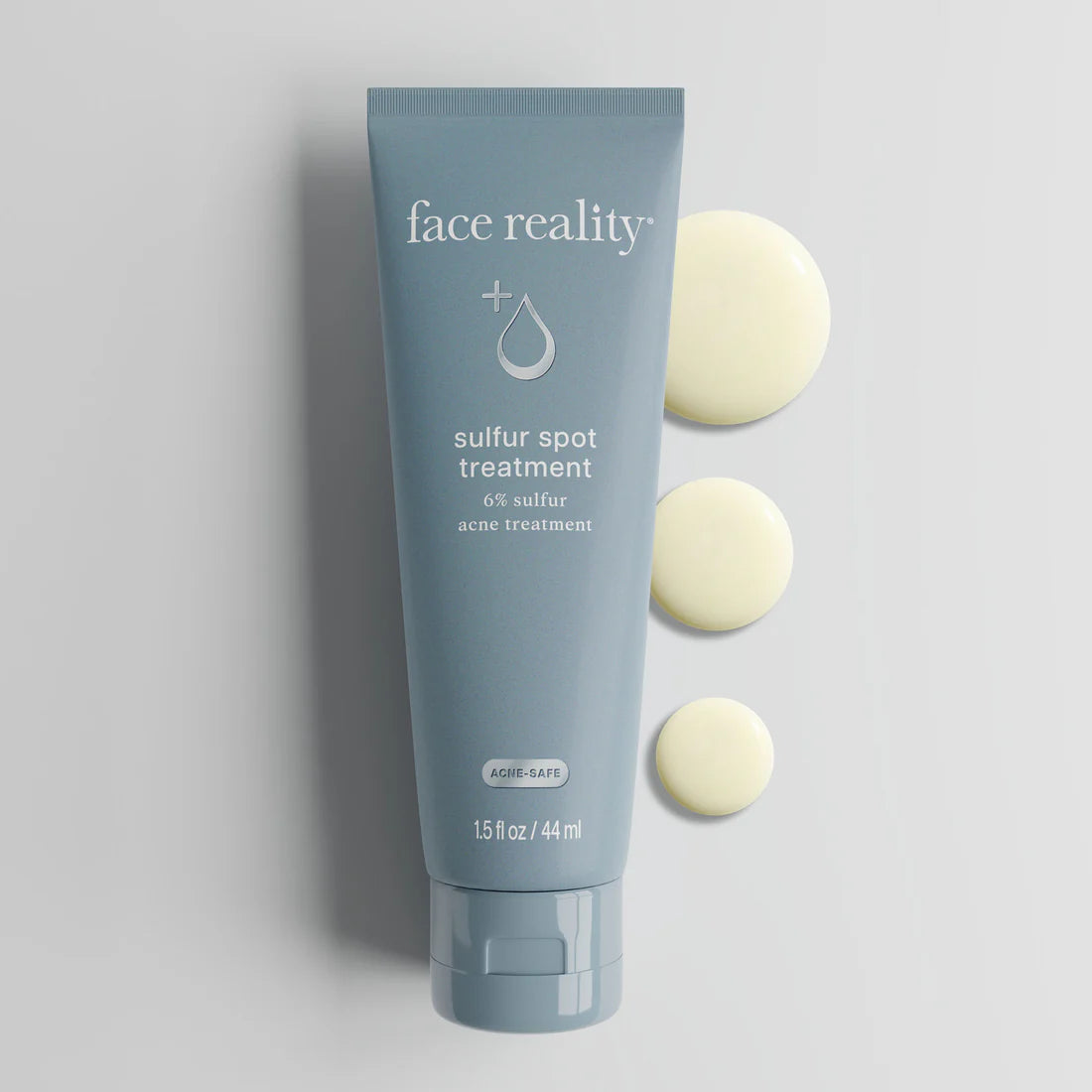 Tube of 'face reality' sulfur spot treatment on a gray background