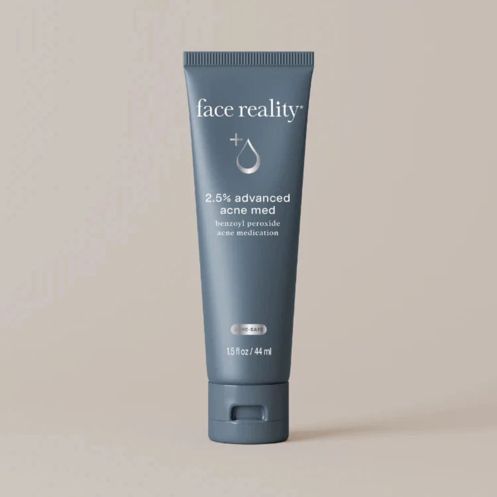 Tube of 'face reality' 2.5% advanced acne med on a beige background