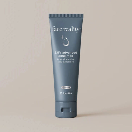 Tube of 'face reality' 2.5% advanced acne med on a beige background