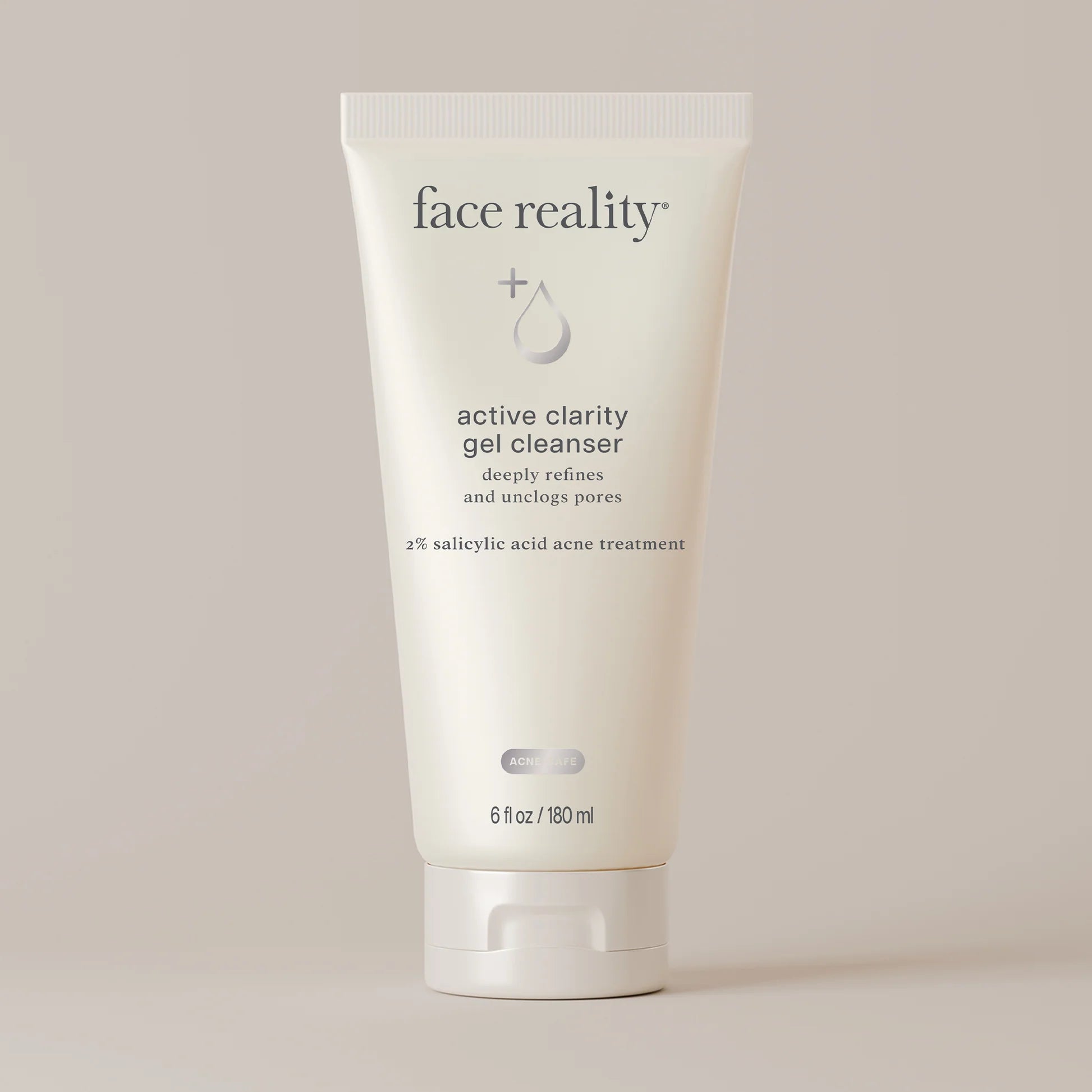 A single tube of Face Reality Active Clarity Gel Cleanser standing upright against a warm beige background. The tube is off-white with black text and a small gray droplet logo.