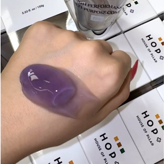 Hand holding a purple HOP Promoter Gel with 'House of PLLA' branding in the background