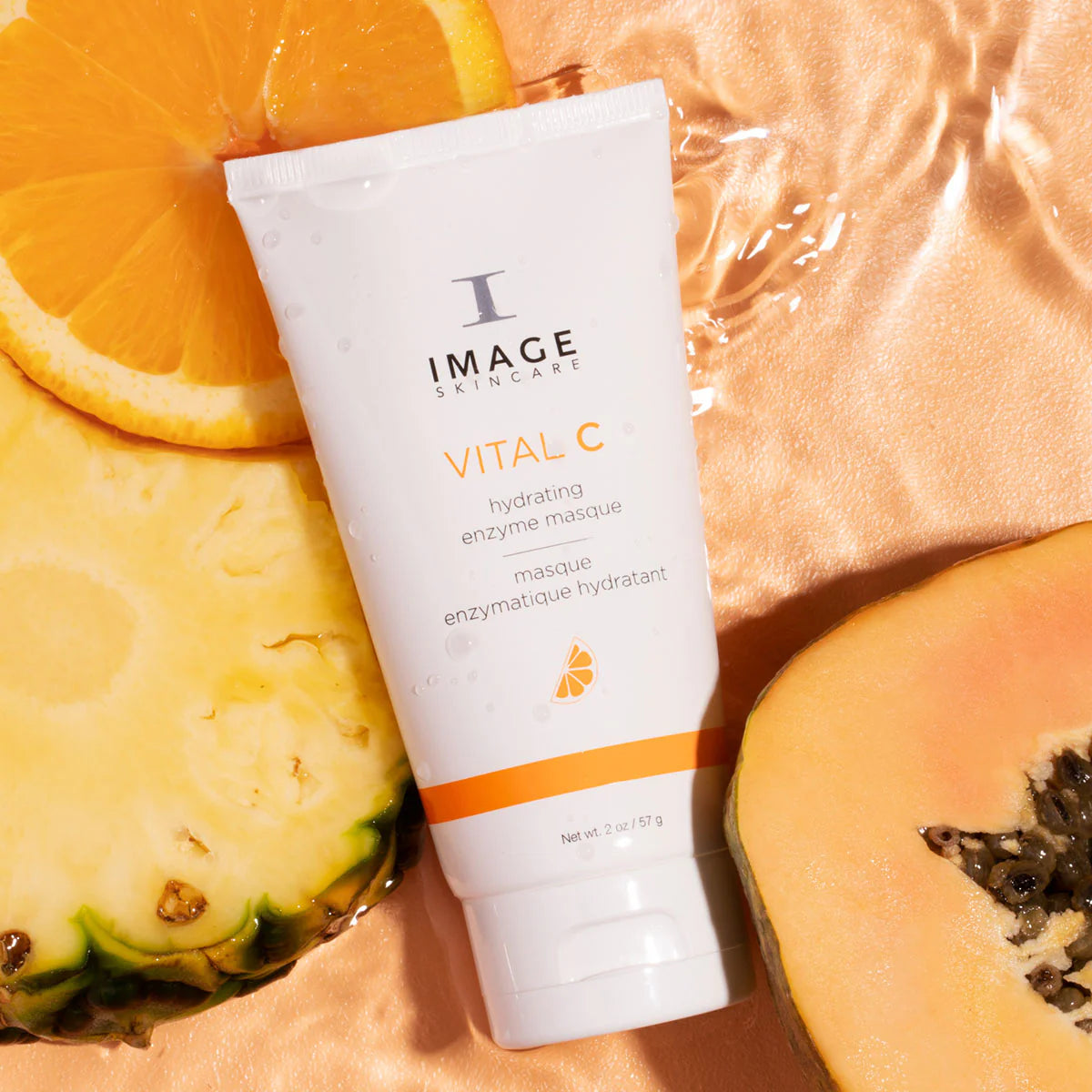 Tube of Image Skincare Vital C mask with sliced pineapple and orange on a peach background