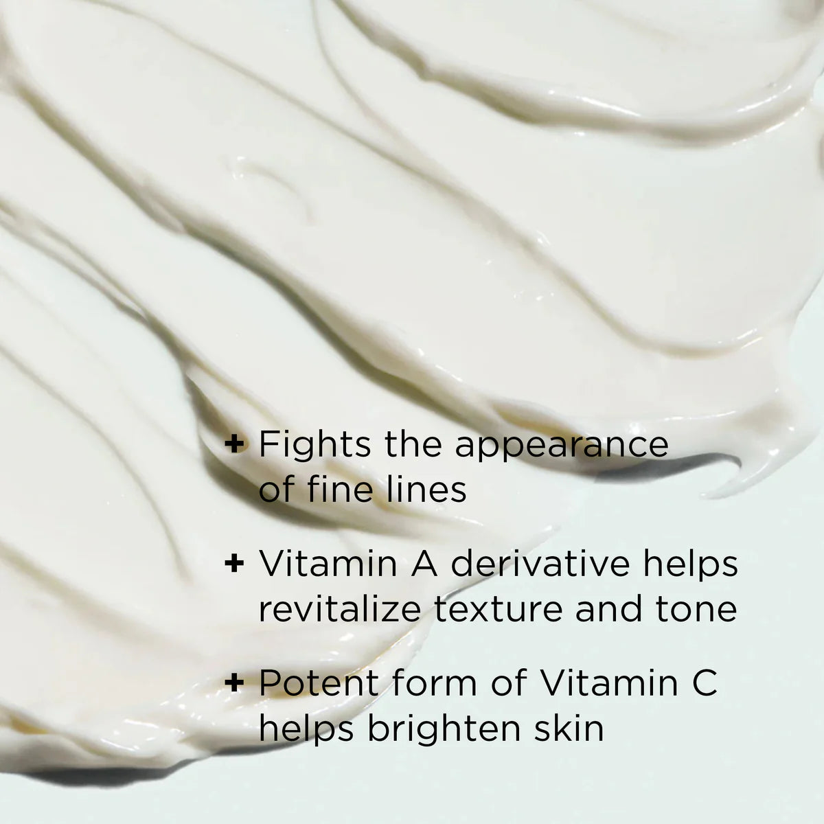 White cream being spread on a white surface with text about skincare benefits.