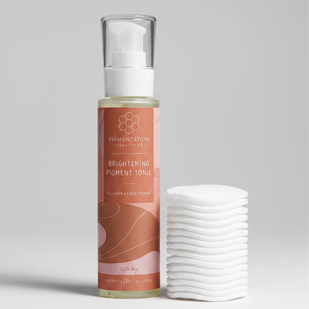 Bottle of Brightening Pigment Tonic on a light gray  background with cotton pads