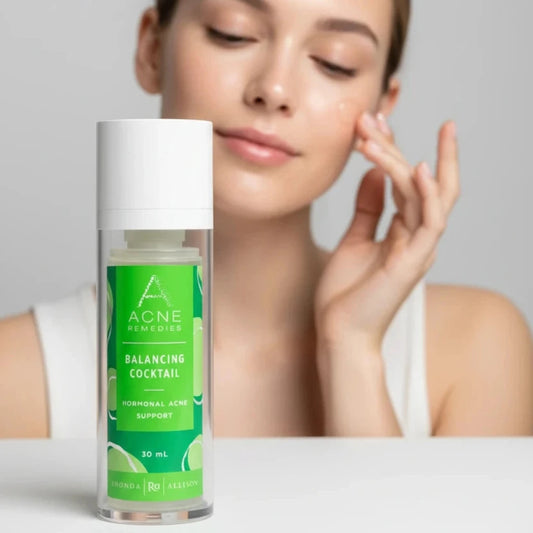 Acne Remedies Balancing Cocktail bottle with green label on a white background with woman