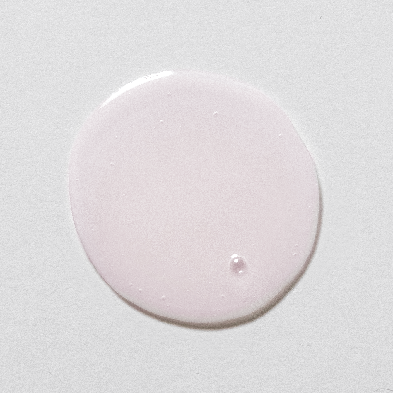 Pink circular product smear on a white background