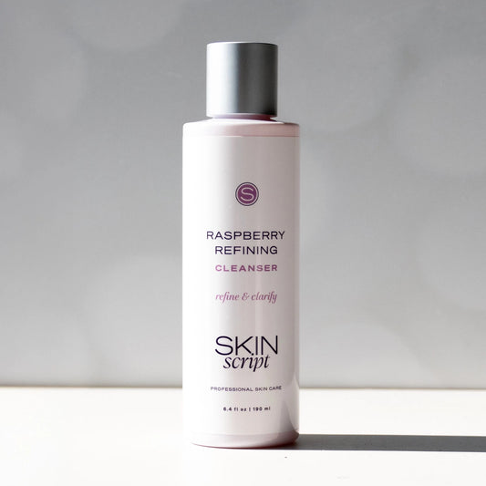 Skincare bottle labeled 'Raspberry Refining Cleanser' by 'Skin Script' on a neutral background