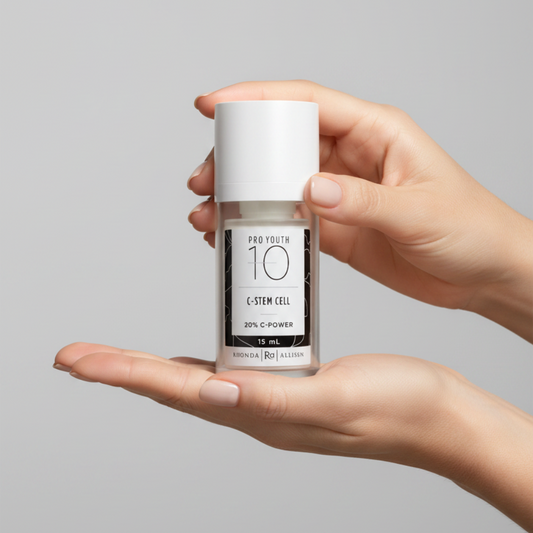 Skincare serum bottle labeled 'Pro Youth 10 C-Stem Cell' by Rhonda Allison held by woman's hands