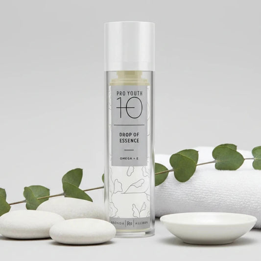 Rhonda Allison Skincare bottle labeled 'Pro Youth 10' Drop of Essence with towel on a white background