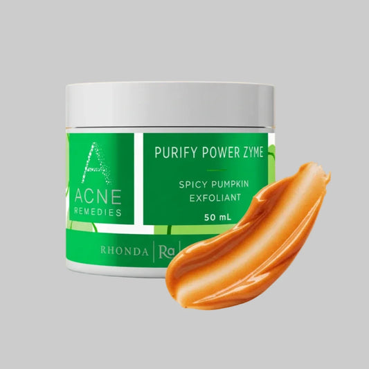 Green jar of Acne Remedies Purify Power Zyme Spicy Pumpkin Exfoliant on a grey background