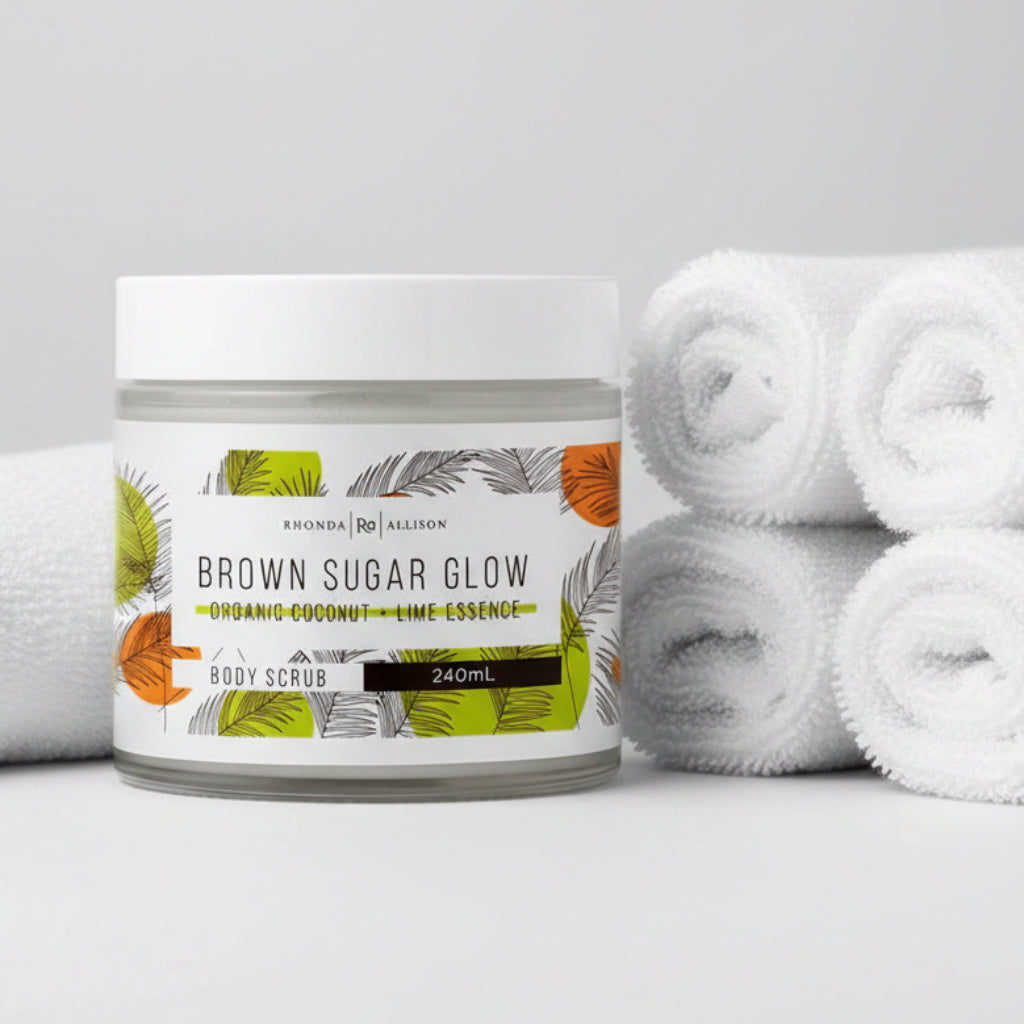 Jar of 'Brown Sugar Glow' body scrub with leaf design on a white background