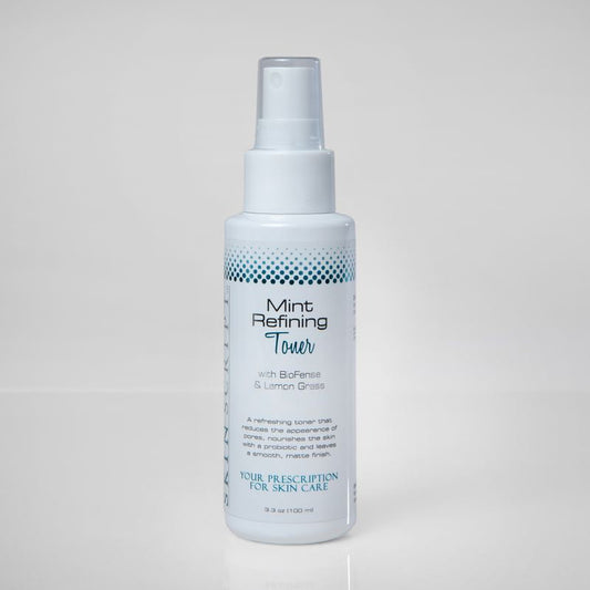 Skin Script Bottle of Mint Refining Toner on a light gray backgrounding