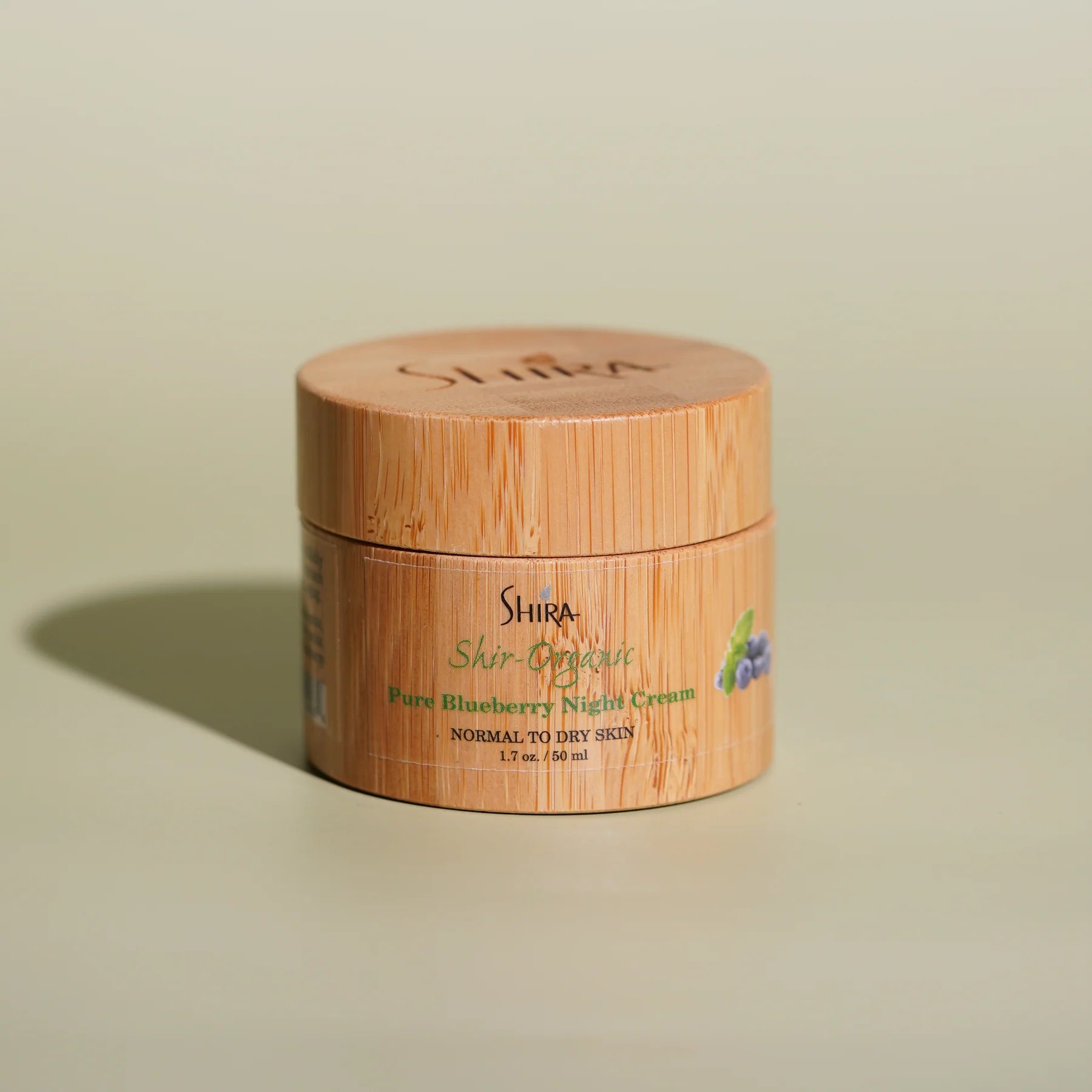 Shira Skincare jar with bamboo lid on a beige background
