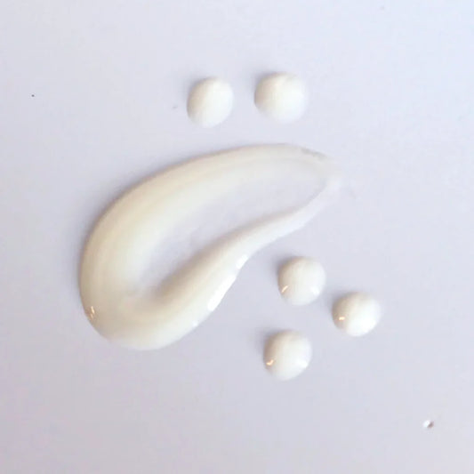 Skin Script Mandelic Brightening Serum smear on a light grey background