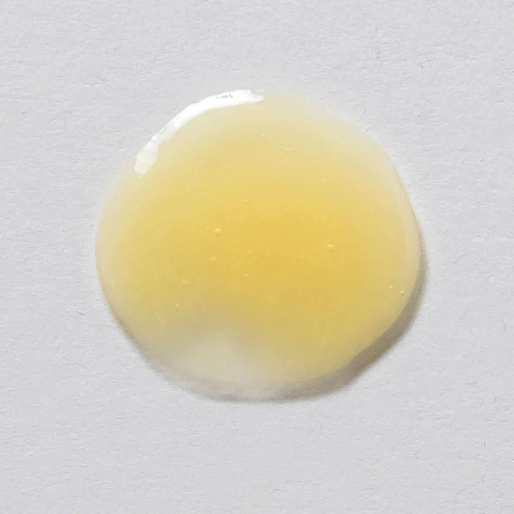 Skin Script Peptide Eye Serum pale yellow Smear on a grey background 