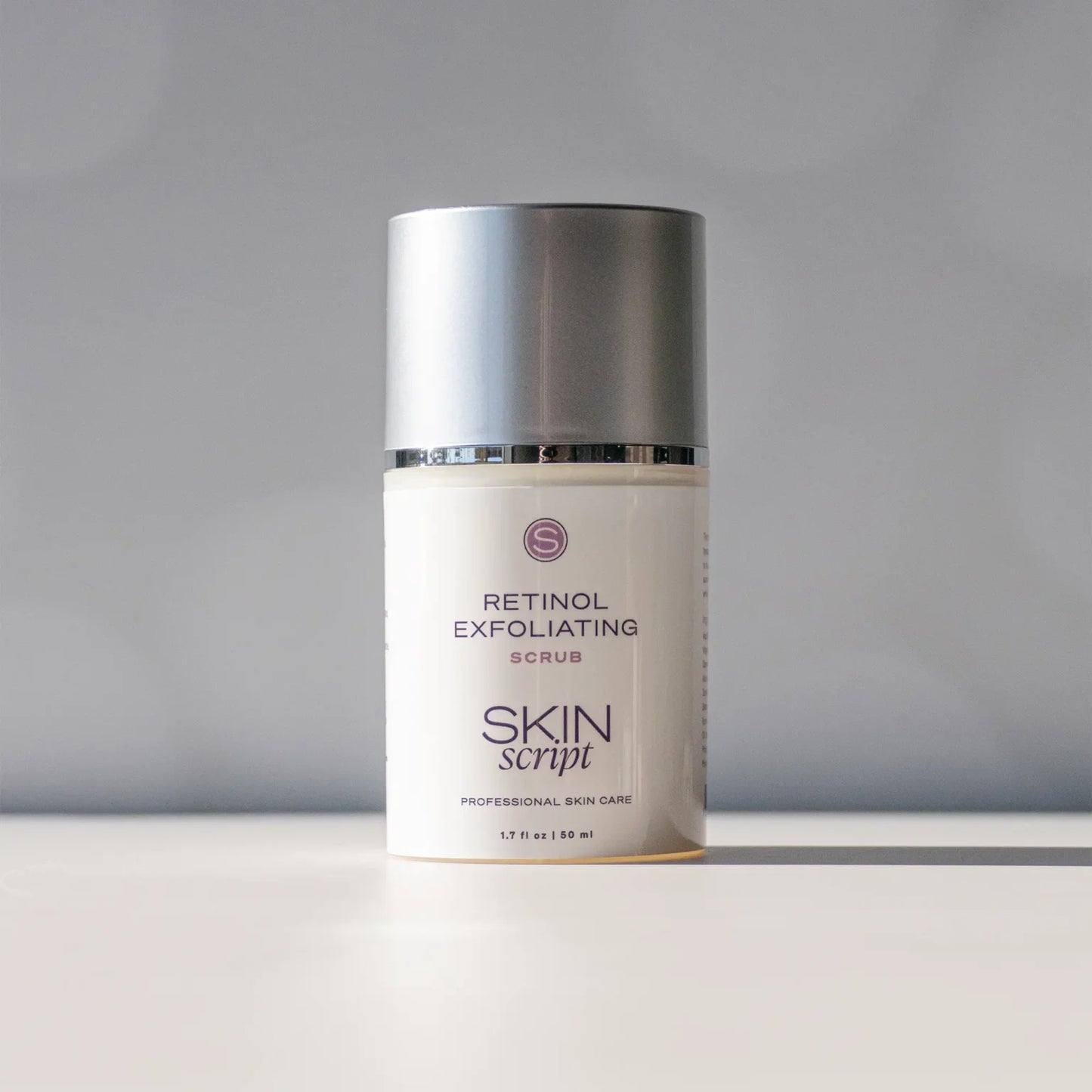 Skincare product labeled 'Retinol Exfoliating Scrub' by 'Skin Script' on a gray background