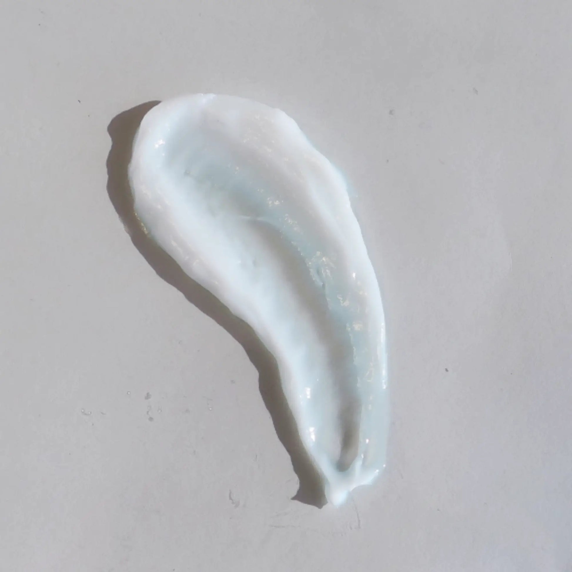 Skin script Ageless Skin moisturizer Smear on a light grey background