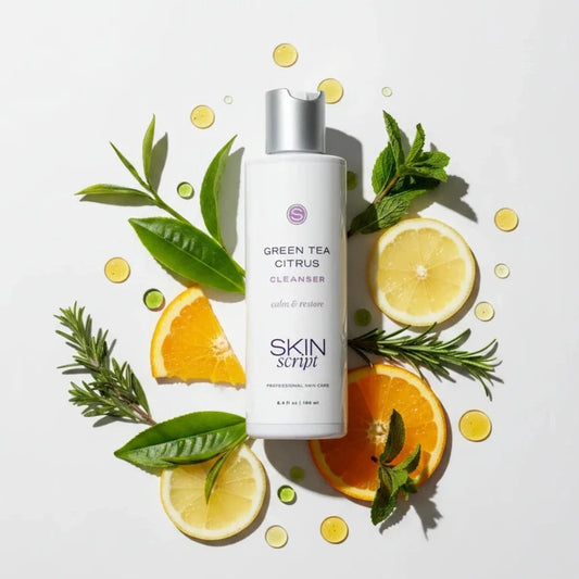 Cleanser bottle with purple lettering reading Skin script Green Tea Citrus Cleanser with botanicals on a white background