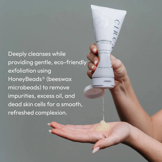 Hand holding a skincare product with text about its benefits on a gray background