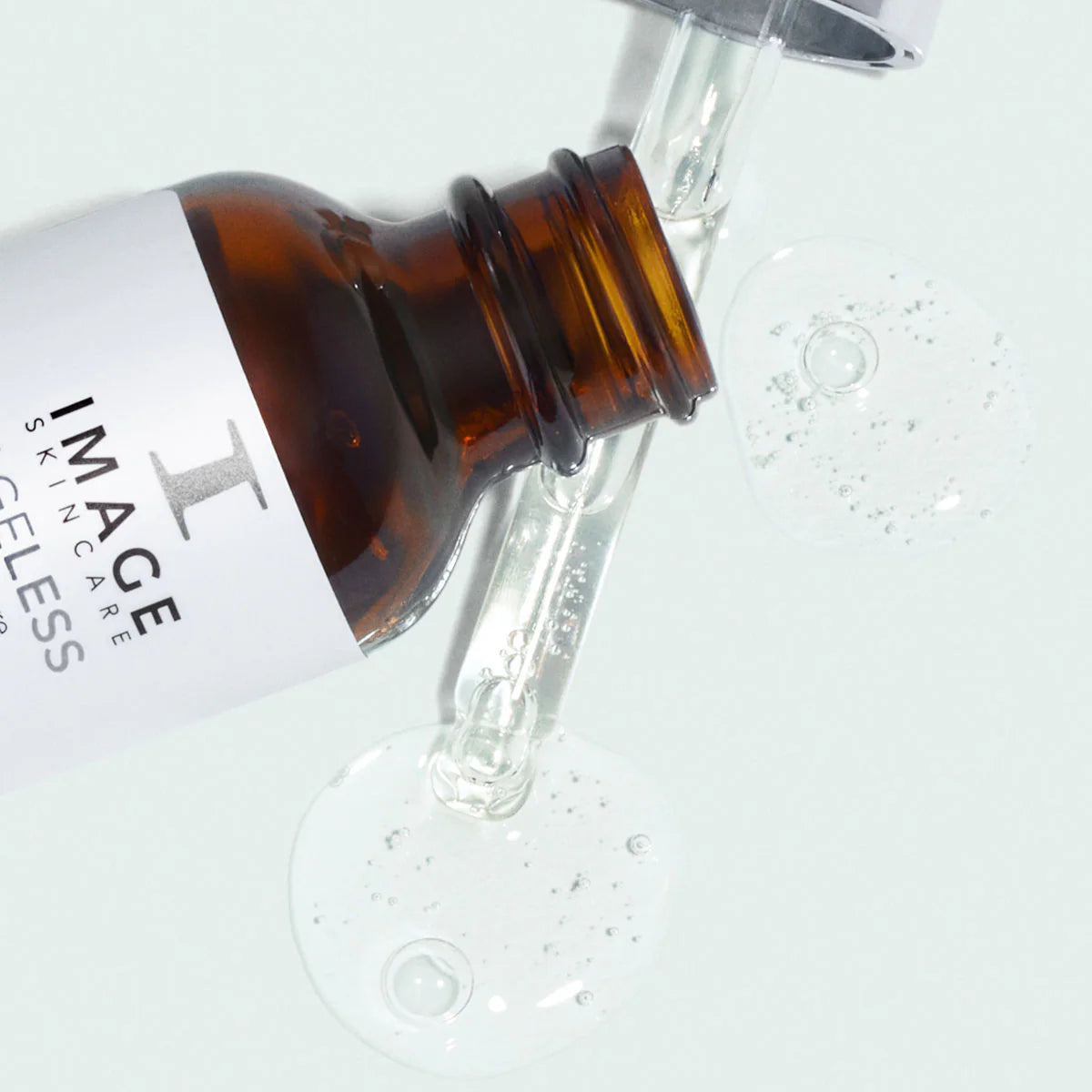Close-up of a dropper bottle with 'IMAGE Skincare' label on a light gray background