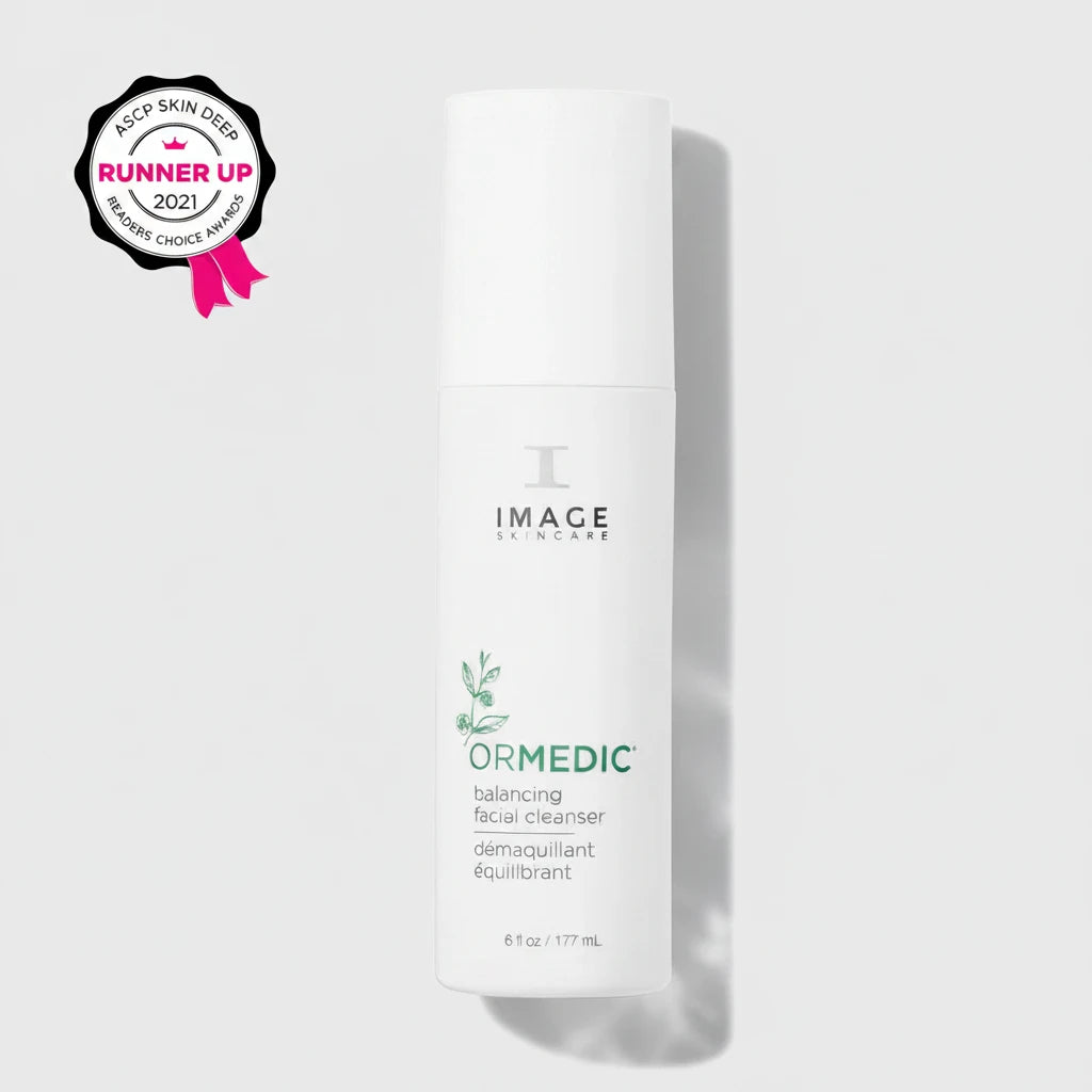 White skincare bottle labeled 'Image Skincare Ormedic Balancing Facial Cleanser' on a light grey background