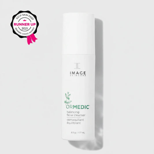 White skincare bottle labeled 'Image Skincare Ormedic Balancing Facial Cleanser' on a light grey background