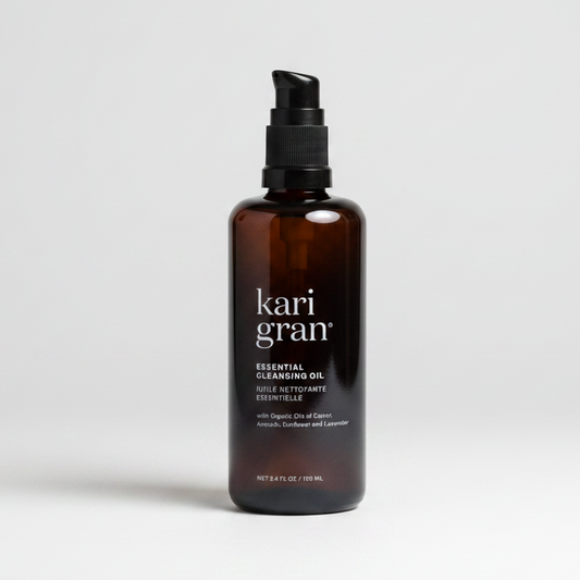 A black bottle with a pump dispenser labeled Kari Gran Essential Cleansing Oil, with white and silver text on the label.