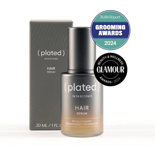 Plated hair serum bottle and packaging with awards on a white background