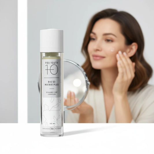 Skincare bottle labeled 'Pro Youth 10' BIO 53 Matrix Plus on a white background with woman applying product