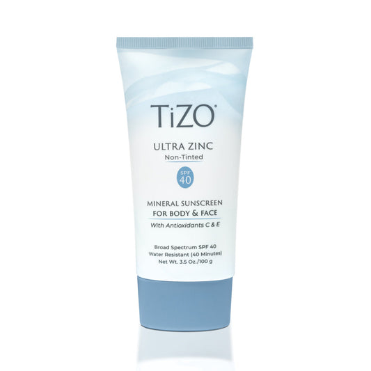 A tube of TiZO Ultra Zinc non-tinted mineral sunscreen for body and face with SPF 40. The packaging is predominantly white and blue with text detailing the product's features.
